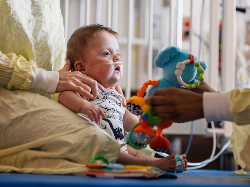 The stimulation from brightly colored toys is helping John Corbett Bradley of Chunky build developmental skills. Joe Ellis/ UMMC Communications