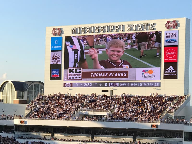 Kid Captain Thomas Blanks of Madison, a Bulldogs fan, is shown on the Jumbotron at Davis Wade Stadium ringing his cowbell.