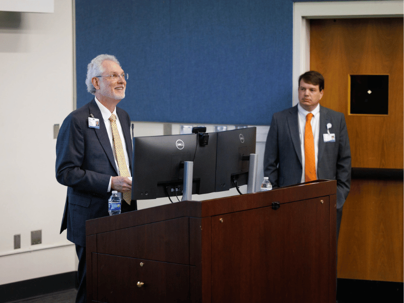 Dr. Patrick O. Smith, left, chief faculty affairs officer and associate dean for faculty affairs in the School of Medicine, introduces Dr. Lee Bidwell, associate vice chancellor for research and a co-presenter for the March 27 session of Faculty Focus: "Navigating Research as a New Faculty Member."