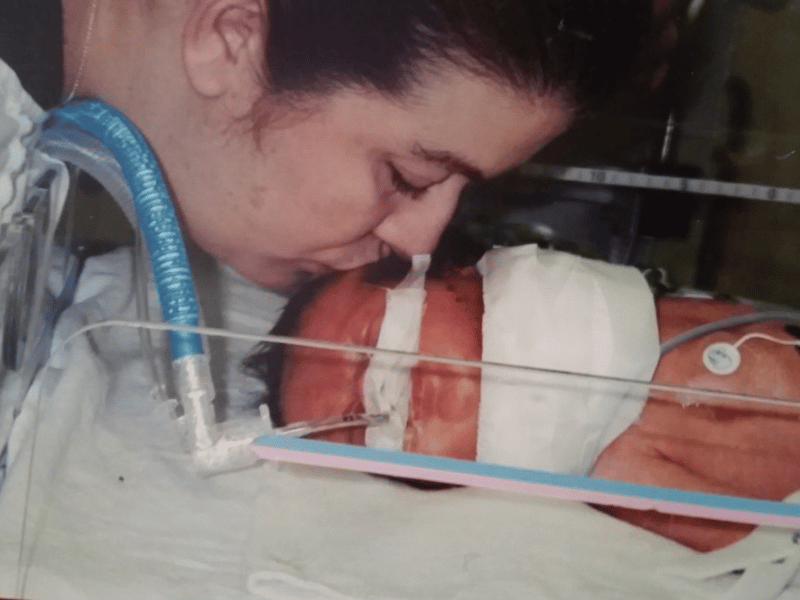 Lambert is shown getting a kiss from her mother during her stay in the NICU.