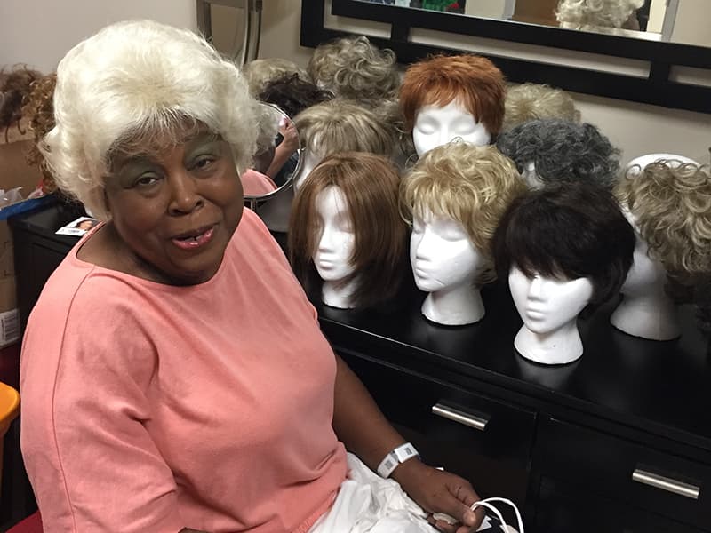 Terethia Goulding models her newly coiffed wig in the UMMC Cancer Institute Patient Resource Center.