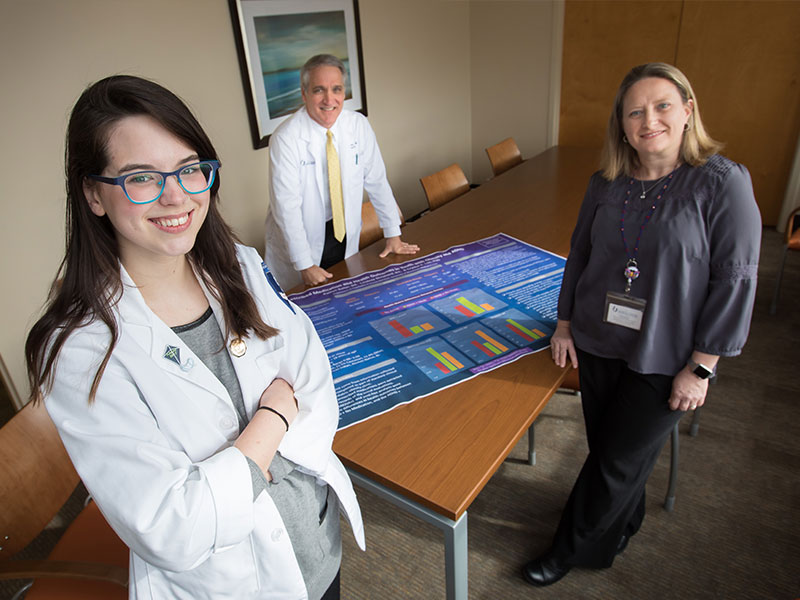 Kaitlyn Salter, foreground, winner of a fellowship award from the American Academy of Child and Adolescent Psychiatry, said she received invaluable help from her mentors, including Dr. Philip Merideth, center, and Dr. Crystal Lim.