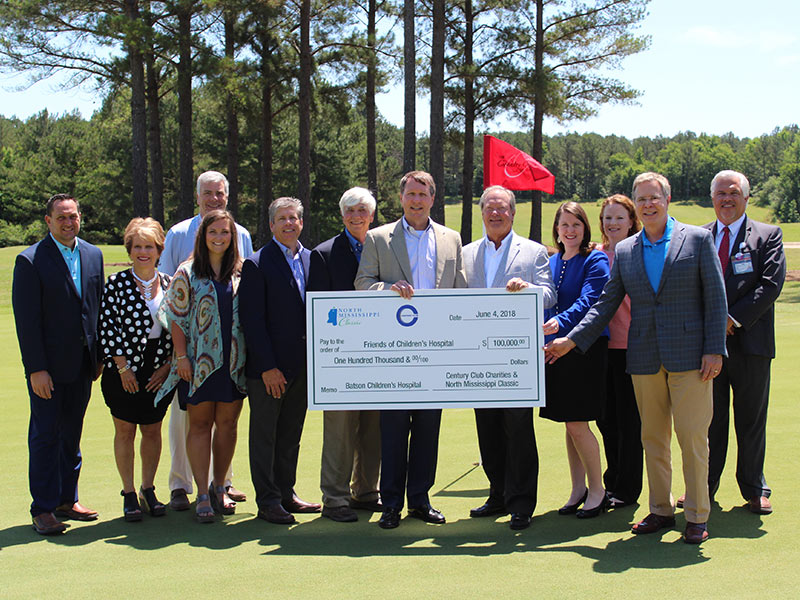 Celebrating the first check presented from the North Mississippi Classic to Friends of Children's Hospital are, from left, John Fassinger, Country Club of Oxford general manager; Becki Huelse; Mark Huelse; Nikki Paine; Steve Jent; Larry Britt; Jeff Hubbard, Century Club Charities president; Sidney Allen, Century Club Charities board chairman; Natalie Hutto, UMMC chief development officer; Emily Lewis, Children's of Mississippi finance director; Dr. Jeffrey Vitter, University of Mississippi chancellor; and Keith Parker, Children's of Mississippi director of ambulatory operations.