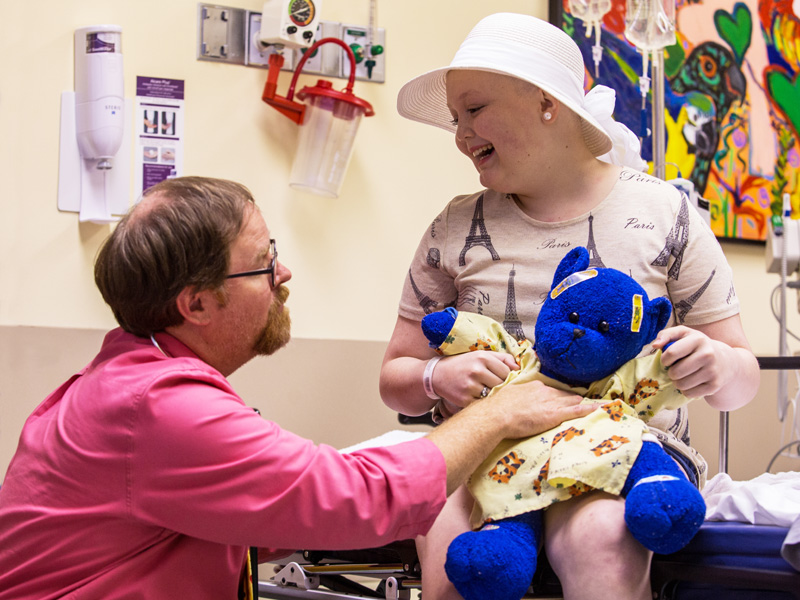 Dr. Anderson Collier checks the condition of Mary Frances Sutton of Monticello, a Children's Cancer Center patient, and her bear, Blueberry.
