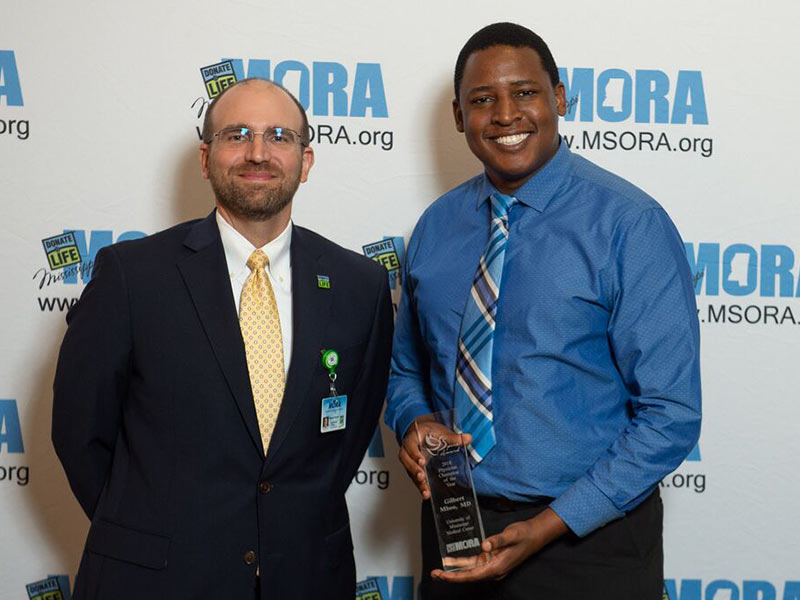 Dr. Gilbert Mbeo, right, assistant professor of neurology, is MORA's Physician Champion of the Year. He's pictured with Russell Touchet, MORA chief business officer.
