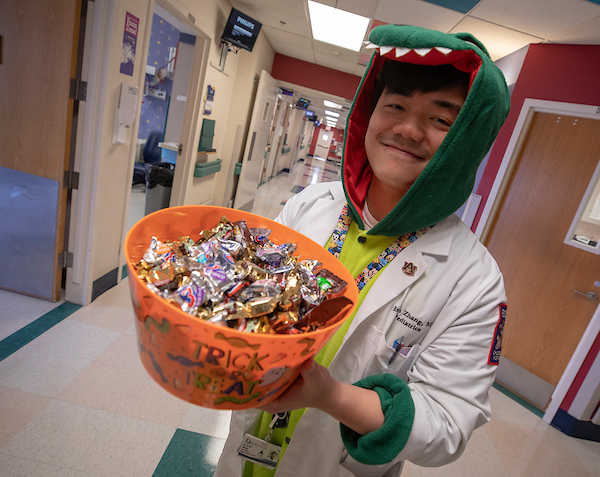 Pediatric resident Dr. Kevin Zhang shows some of the Halloween treats on the fifth floor of Batson Children's Hospital.
