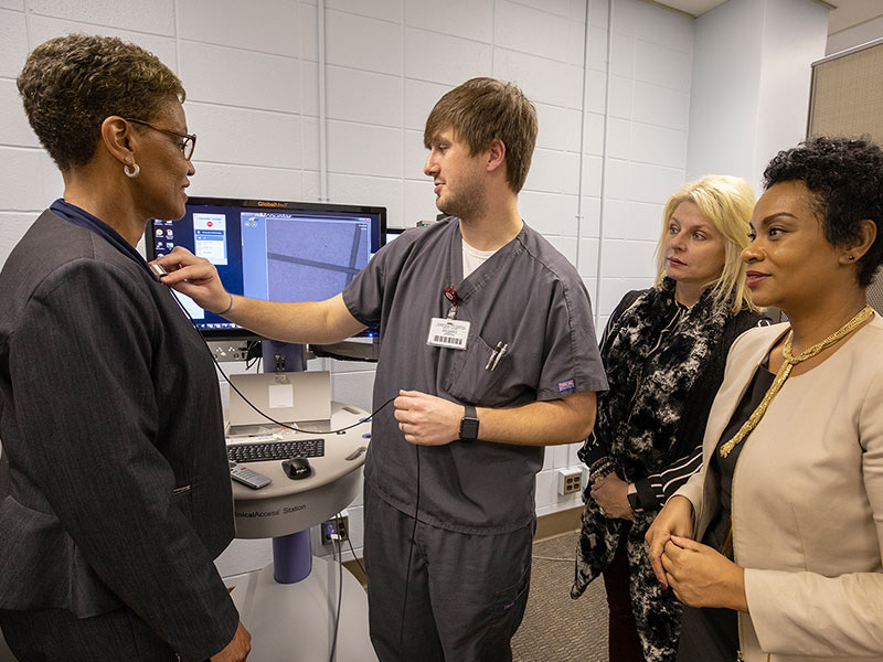 John Farr, nurse practitioner and School of Nursing instructor, explains some of the gadgets used in telemedicine to Mississippi Board of Nursing members. From left, Executive Director Phyllis Johnson, General Counsel Brett Thompson and CFO Shan Montgomery listen to Farr.