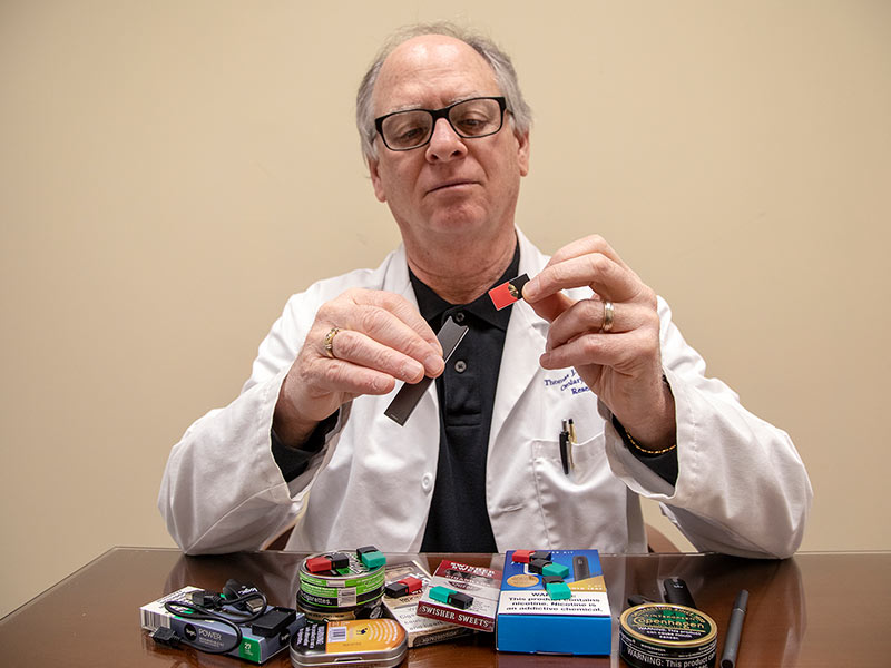 Dr. Thomas Payne explains the use of a Juul e-cigarette in the shape of a flash drive.