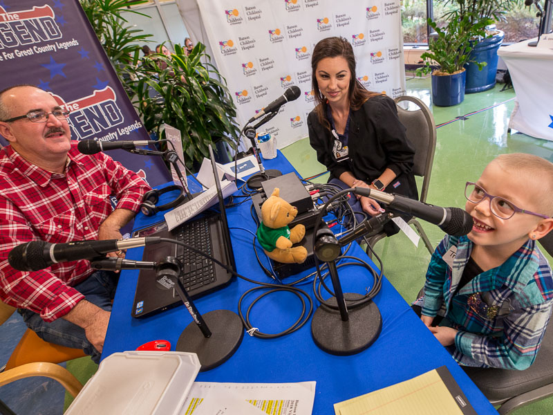Mark McCoy of 100.9 The Legend interviews Children's of Mississippi patient Trinley Camp as her mom, Amanda, looks on.