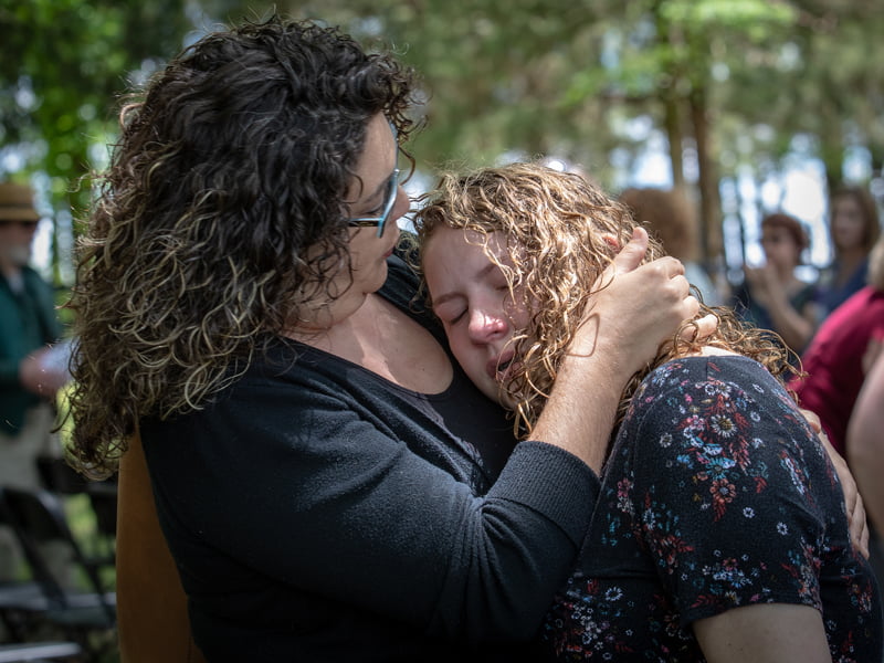 Elizabeth Steelman and her daughter Jasmine Steelman give in to a moment of grief as they remember father and grandfather Norville Jackson, one of 150 body donors honored Wednesday during the Ceremony of Thanksgiving.