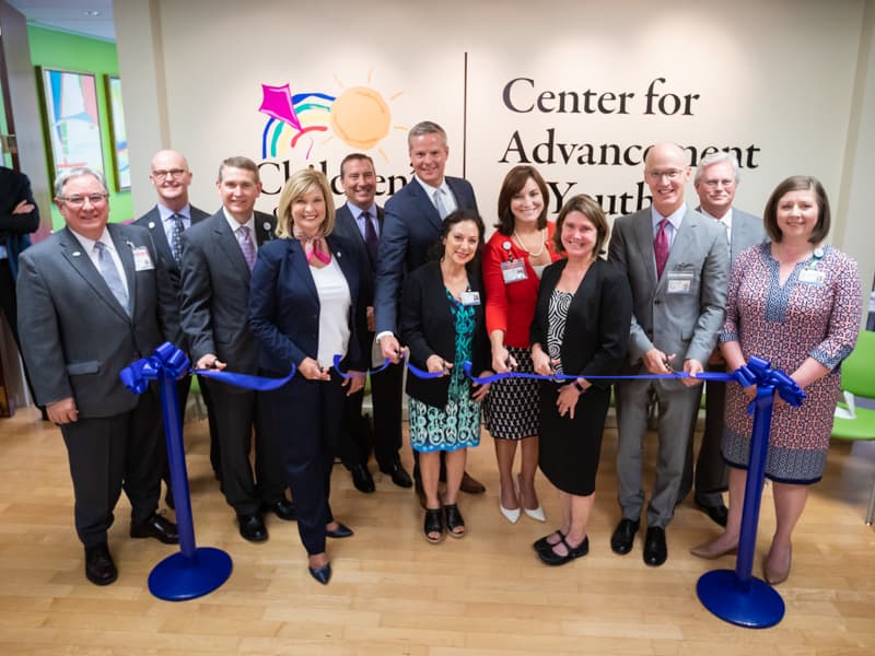 Celebrating the ribbon-cutting for the new location of the Center for Advancement of Youth are, from left, Dr. Ralph Didlake, Dr. Charles O'Mara, Guy Giesecke, Dr. LouAnn Woodward, Kevin Cook, Dr. David Elkin, Dr. Susan Buttross, Dr. Mary Taylor, Anne Travis, Dr. Scott Rodgers, Dr. Richard Summers and Dr. Barbara Saunders.