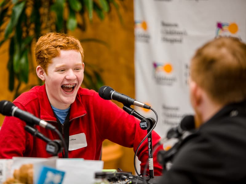 In this photo from the 2020 Mississippi Miracles Radiothon Griffin Threatt of Clinton, a Children's of Mississippi patient, talks with Ryan Johnson of Q101 in Meridian.