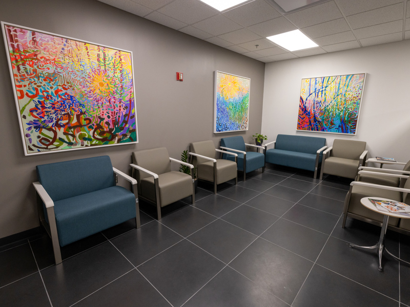 The refurbished waiting area of UMMC's Adult Special Care clinic at the Jackson Medical Mall includes partitions for privacy and vibrant local art.