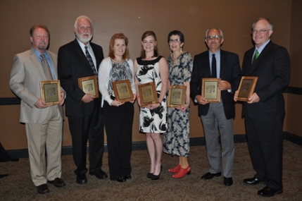 Seven Hembree Society winners holding plaques.