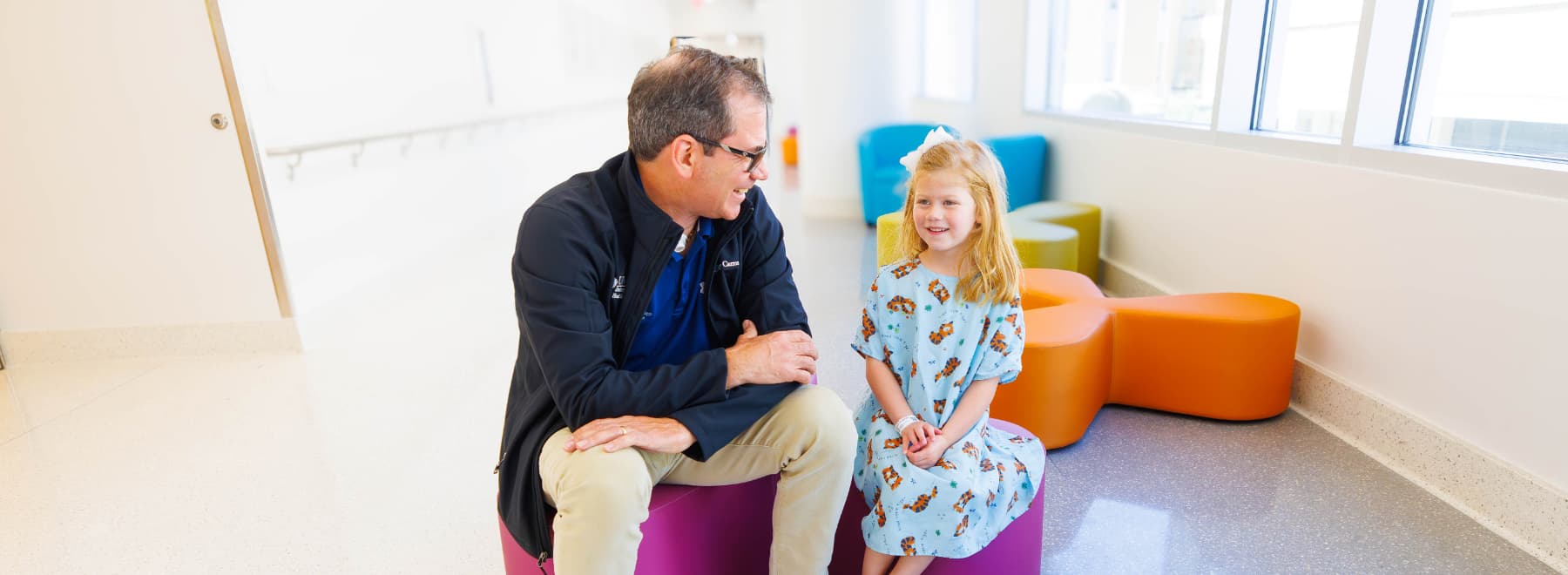 Dr. Jeffrey Carron with young patient in hospital gown