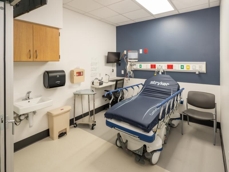 Patient room with wheeled hospital bed.