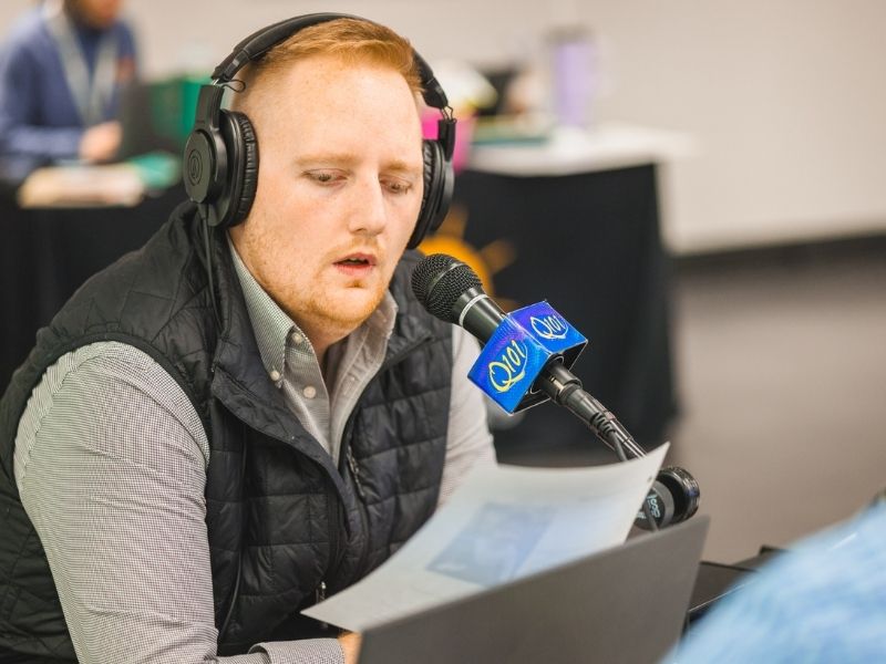 Ryan Johnson of Q101, a New South Radio station in Meridian, reads over information before a Mississippi Miracles Radiothon interview.