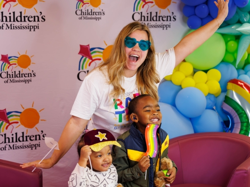 Hannah Lane with US96 radio station poses with patients during the Mississippi Miracles Radiothon.