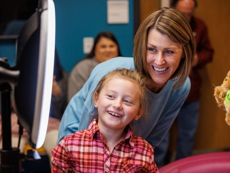 Children's of Mississippi patient Mary Mosley Pickering of Philadelphia and mom Jessica Pickering smile for a photo during the Mississippi Miracles Radiothon.