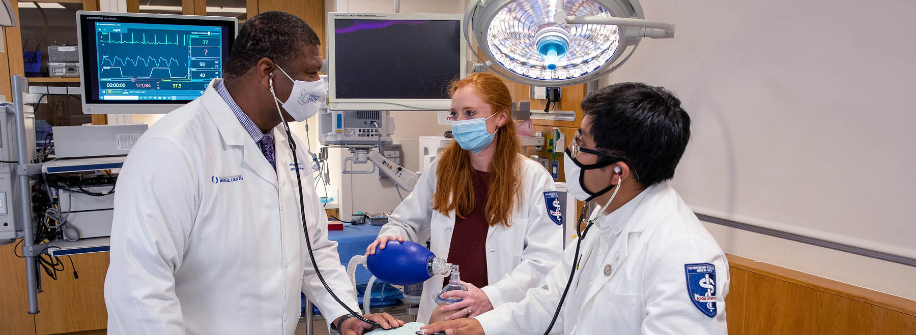 Medical students interact with a member of the faculty