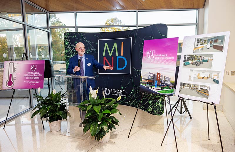 Dr. Mosley points to architectural renderings of The Fred R. Adams, Jr. MIND Center and Geriatric Clinic, a state-of-the-art facility that will span 30,000 square feet.