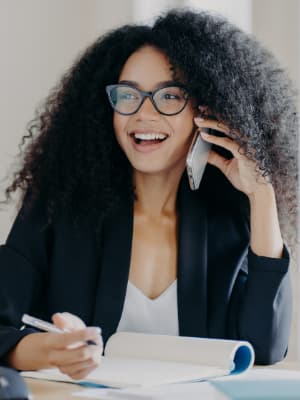 A smiling woman wearing a headset.