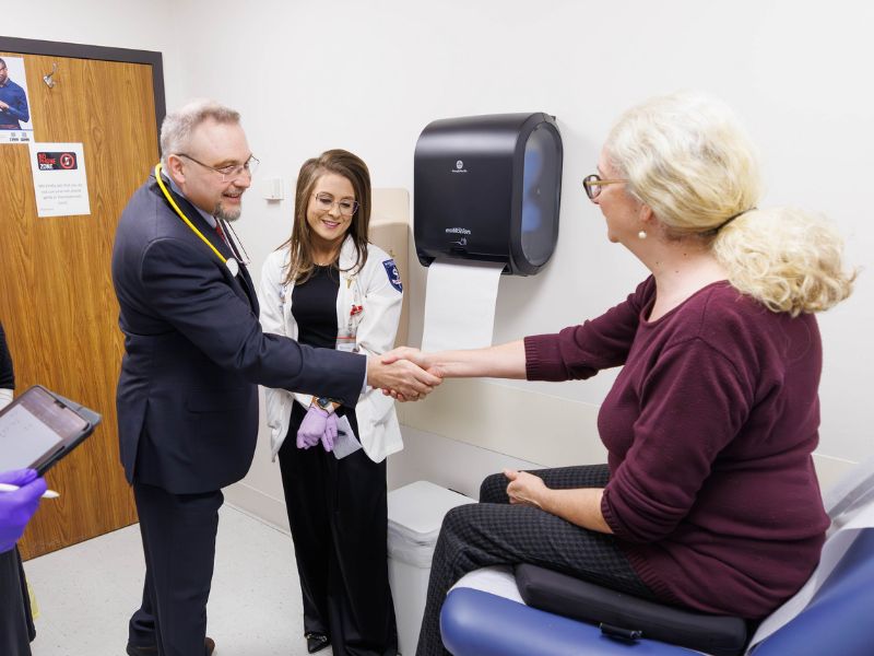 Dr. Pavel Pomianowski greets a patient with a handshake.