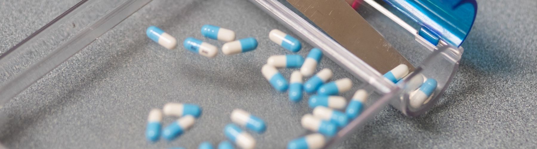 A closeup of a pill counter with pills inside.