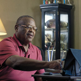 Coach Leroy Henderson using tablet for telehealth session