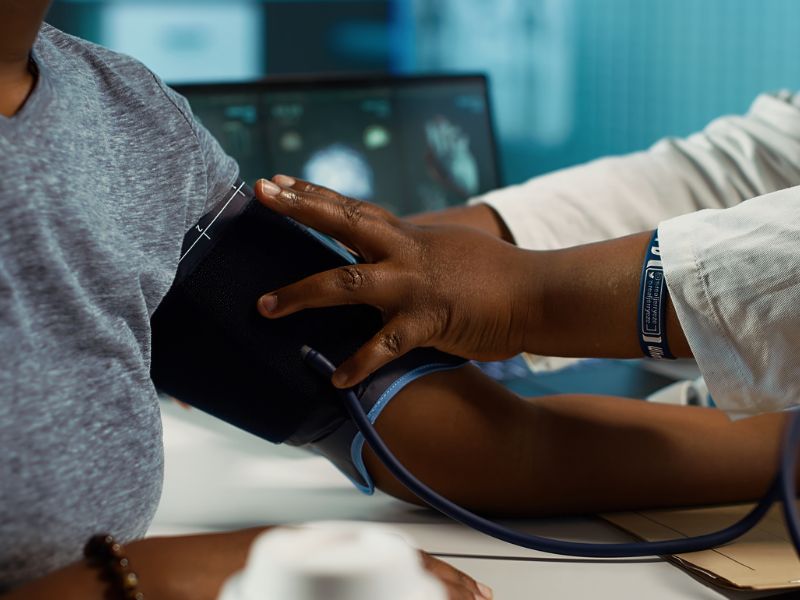 Physician expert measuring blood pressure at a consultation with girl