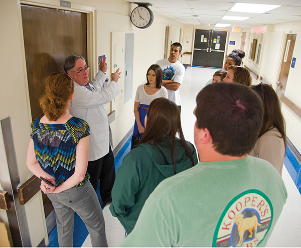 Leading a Millsaps College history class on a historical tour of UMMC in April 2014, Didlake shows students the original ER area where civil rights leader Medgar Evers was brought after he was shot in June 1963.