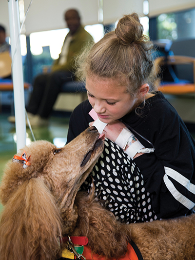 Hannah Abercrombie of McHenry visits with pet therapy dog Honey at Batson Children's Hospital.