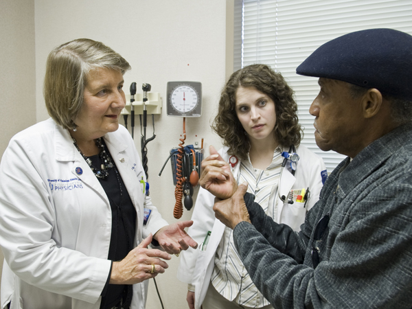 Dr. Diane Beebe and Dr. Kaitlin Gilham confer with patient Clyde Brown.