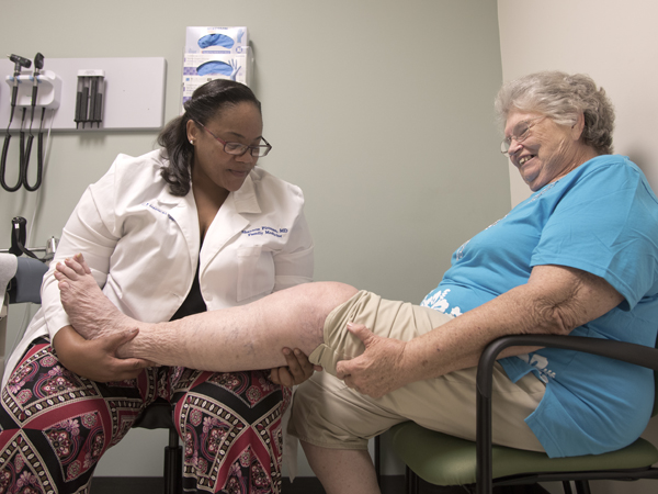 Pittman checks the healing knee of patient Charleen Chandler of McComb.
