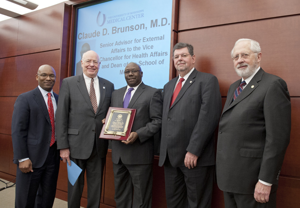 Presenting Brunson with his award are (from left) IHL Trustee Shane Hooper, Dr. James Keeton, Vice Chancellor for Health Affairs and Dean, School of Medicine, Brunson, Dr. Morris Stocks, Provost, The University of Mississippi, and Trustee Aubrey Patterson, President of the Board of Trustees.