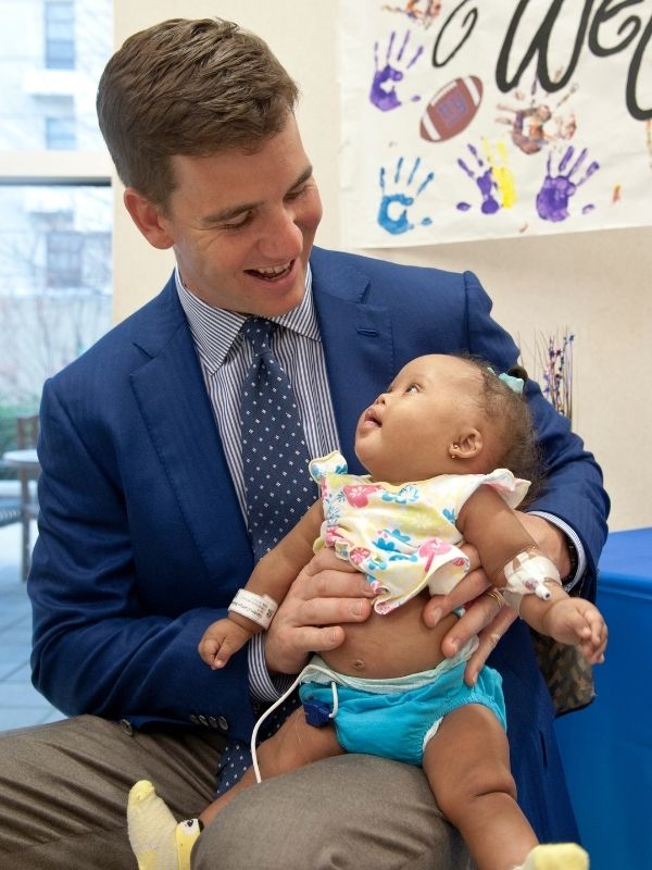 Manning meets one of his smallest fans, Caitlyn Hardin