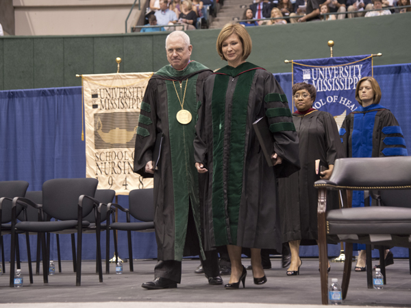 University of Mississippi Chancellor Dr. Dan Jones and Dr. LouAnn Woodward, UMMC vice chancellor for health affairs and dean of the School of Medicine, process to the stage during commencement.