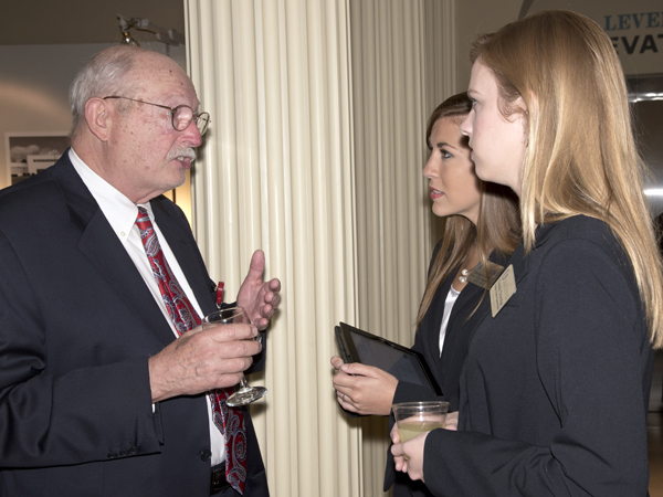 Dr. James Williford of Hattiesburg holds forth with STARS and M2s Meagan Henry, center, and Natalie Ethridge during the Medical Alumni & Friends Awards Dinner, August 15, at River Hills Country Club in Jackson.