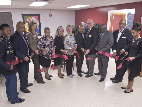 Taking part in the ribbon-cutting for the Lanier High School Teen Wellness Clinic were (from left) Lanier student Jaylin Rodgers, an ROTC cadet lieutenant colonel; Principal Eric Johnson; University of Mississippi School of Nursing Dean Dr. Kim Hoover; Lanier alumnus Hazel Shields; Dr. Janet Harris, School of Nursing associate dean and director of practice and community engagement; Dr. Kate Fouquier, a certified nurse midwife and associate professor in the School of Nursing; Jackson Public Schools Superintendent Dr. Cedrick Gray; Dr. James Keeton, former UMMC vice chancellor for health affairs and now distinguished professor and advisor to the vice chancellor; Dr. Claude Brunson, UMMC senior advisor to the vice chancellor for external affairs; Jackson businessman and Lanier alumnus Al Thomas; and Lanier senior Lauren Porter, granddaughter of the late Dr. Aaron Shirley.