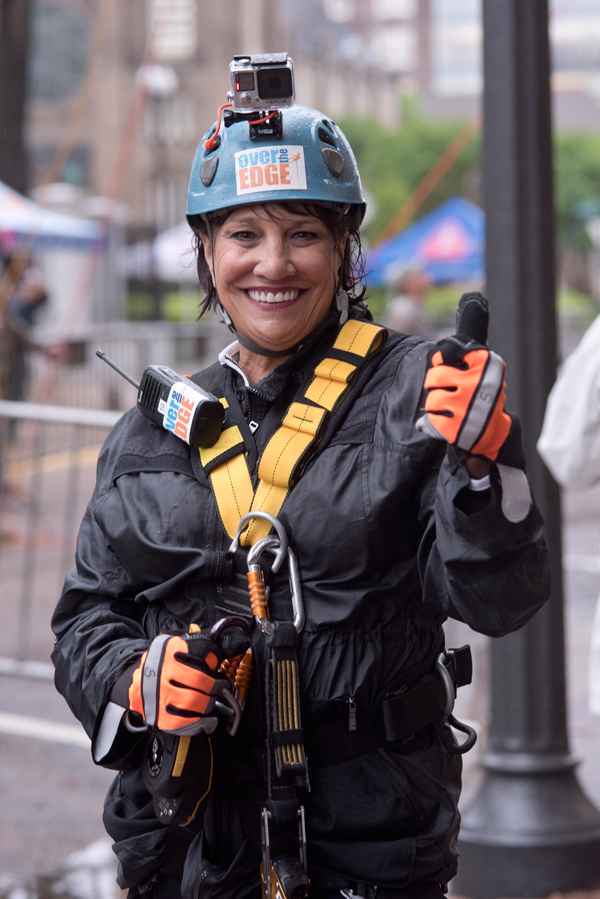 Friends of Children's Hospital board president Sara Ray gives a thumbs up to rappelling after coming down 14 stories in the Over The Edge with Friends fundraiser.
