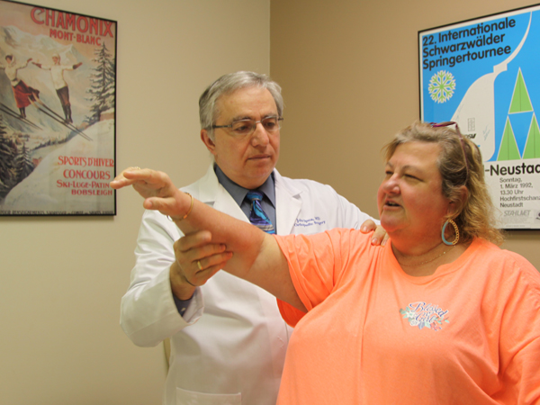 Speca tests the range of motion on patient Jennifer James, who suffered a dislocated shoulder.