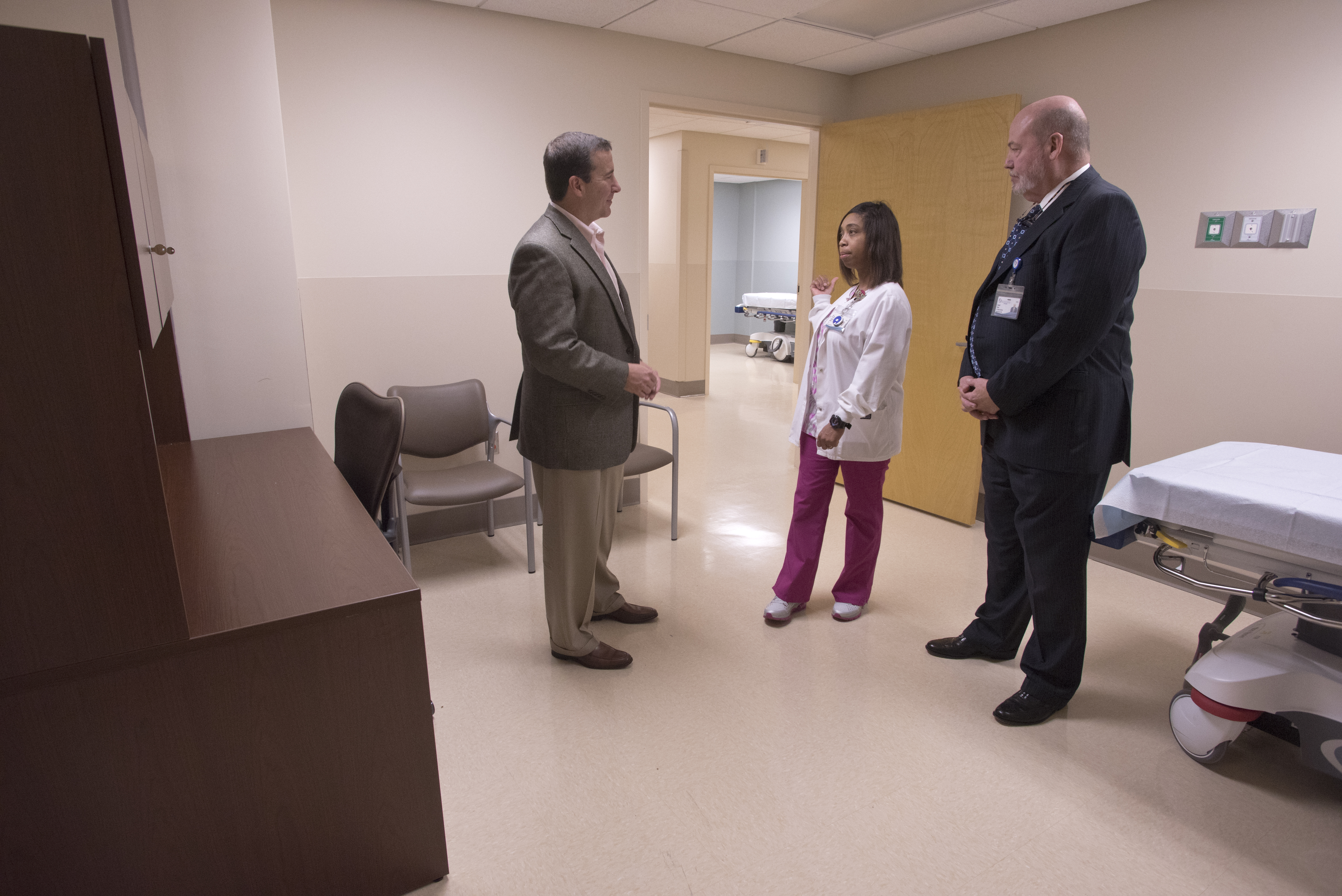 Kevin Cook (left), CEO of University Hospitals and Health System, and David Putt, CEO of UMMC Holmes County and UMMC Grenada, get a tour of the Lexington hospital's new Emergency Department triage room from registered nurse Lakessha Head.
