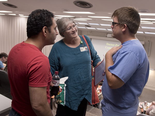 Schlessinger introduces herself to Dr. Sohiel Khoshroo, left, an anesthesiology resident, and neurosurgery resident Dr. Zachary Smalley during an orientation session for new Medical Center residents in June.