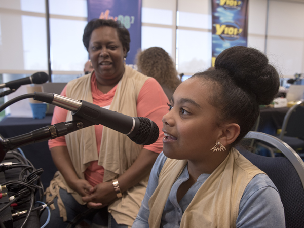 Zeporah Levy listens to daughter Destiny Triplett sing a favorite song from "Frozen" during her time as a spokesperson in the Mississippi Miracles Radiothon.