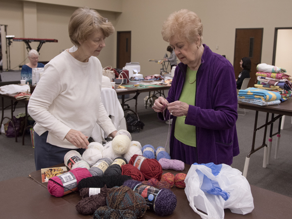 Karen Hill, left, and Helen Goldman look over yarns to hand-tie prayer quilts for Batson Children’s Hospital patients during a sewing day at Christ United Methodist Church in Jackson.