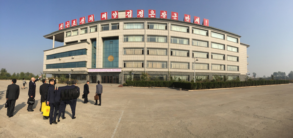 Attendees of the 3rd International Conference of Science and Technology approach the main academic building at Pyongyang University of Science and Technology.