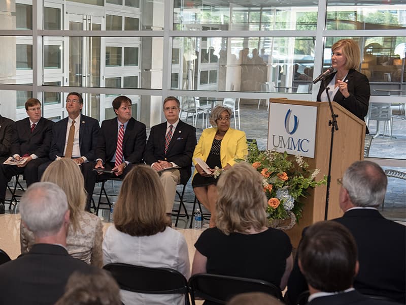 Dr. LouAnn Woodward, UMMC vice chancellor for health affairs and dean of the School of Medicine, addresses dignitaries attending dedication ceremonies for the new School of Medicine.