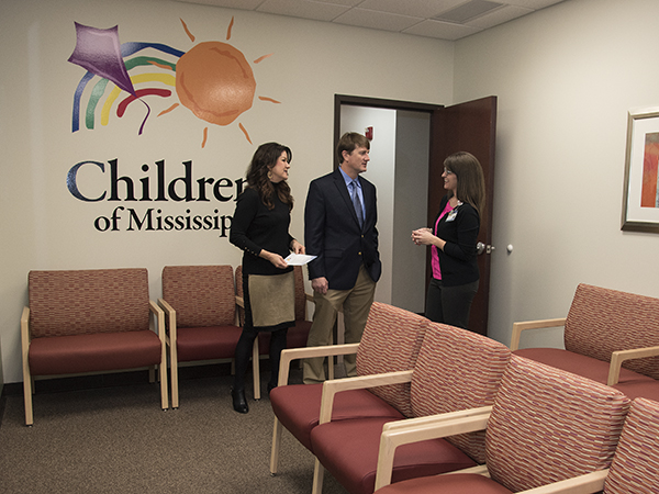 Ashley Williams, right, pediatric nurse, takes Dr. Van Wurm and his wife Kim on a tour of the clinic.