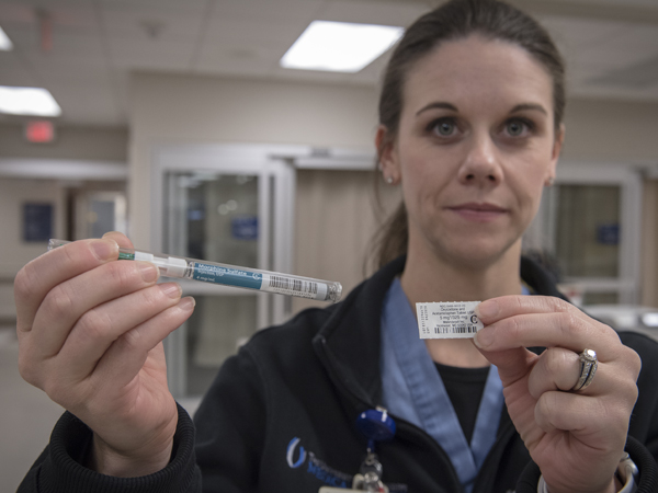 Stephanie Tesseneer, a pharmacist in the Emergency Department, holds opioid drugs that are sometimes administered to patients suffering acute pain.