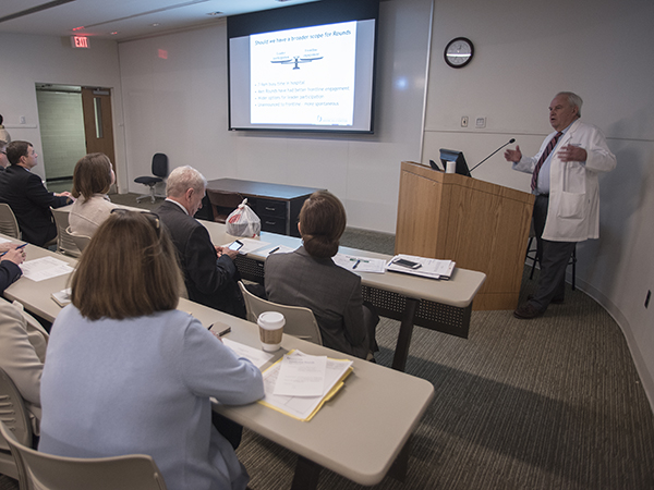 Chief Medical Officer Michael Henderson, upper right, talks to Medical Center executives, physicians and administrators before Leadership Rounds.